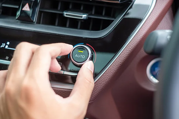 Hand turning A/C temperature dial